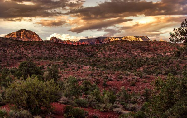 A photograph of the Sedona red rocks under a stormy sunset.