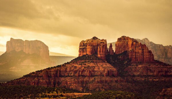 A dramatic photo of Chapel Rock and Courthouse Butte in Sedona, AZ