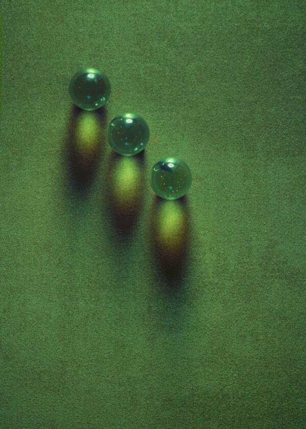 Abstract photo of marbles on a green surface