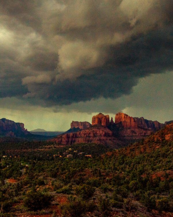 A photograph of dramatic clouds coming in over the Sedona, AZ red rocks