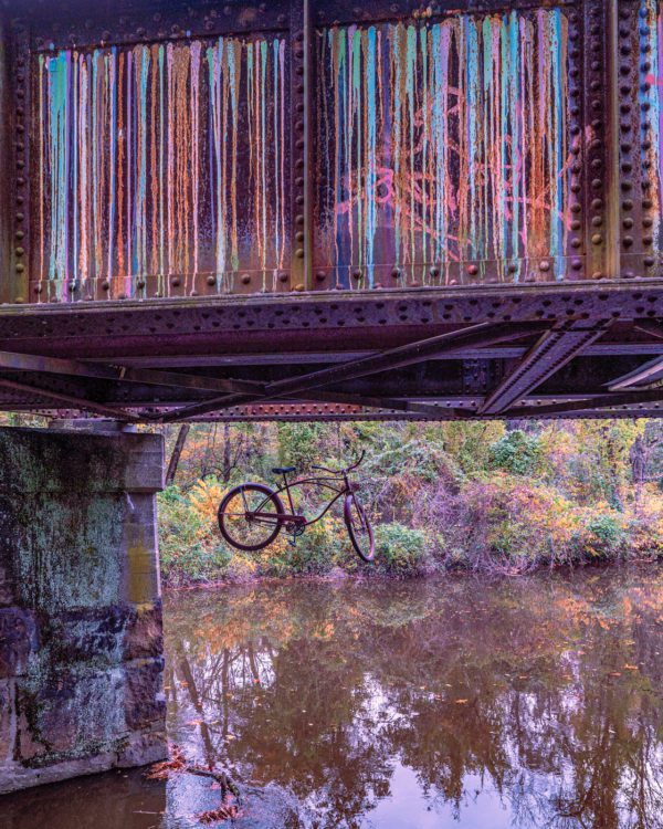 Bike hanging from graffiti bridge in Lambertville, NJ